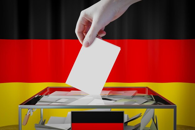 Deutschland-Flaggen-Hand, die Wahlkarte in ein Kastenwahl-Wahlkonzept fallen lässt