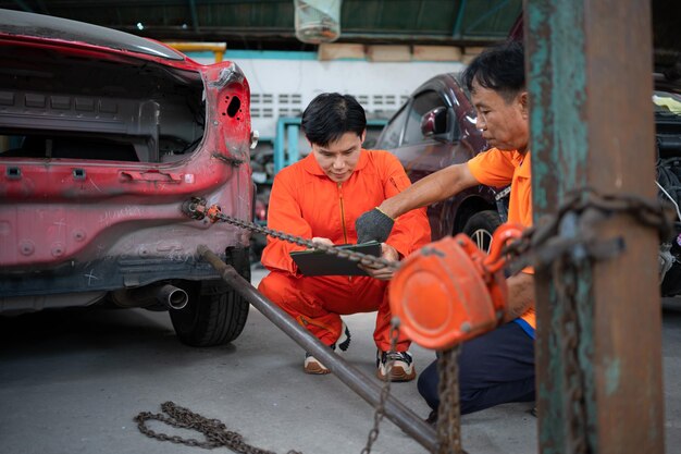 Foto para devolver la carrocería del automóvil a su forma anterior un mecánico de reparación de automóviles