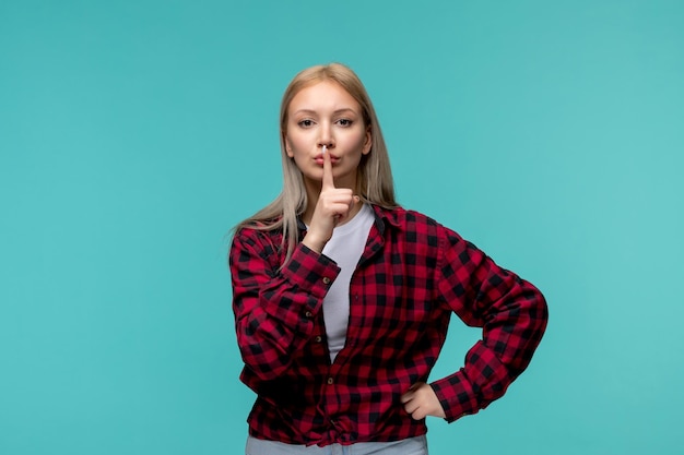 Dia internacional do estudante jovem bonita de camisa vermelha mostrando gesto de silêncio