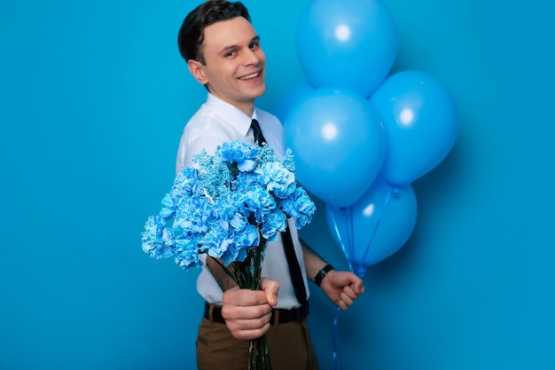 Día de la Mujer Día de San Valentín Cumpleaños Vacaciones presenta Retrato de cerca de un hombre guapo sonriente con camisa y corbata posando con globos y ramo de flores para su amada mujer
