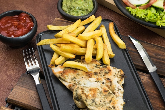 Día Mundial de la Alimentación pechuga de pollo a la parrilla con papas fritas en el comedor comida saludable