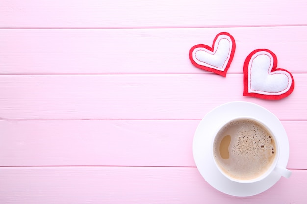 Día de San Valentín, tazas de café con corazones en mesa rosa