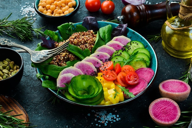 Diätetische Lebensmittel Quinoa Wassermelone Rettich Gurke Tomaten und Spinat Schüssel Buddha Veganes Essen Draufsicht Auf einem Steinhintergrund