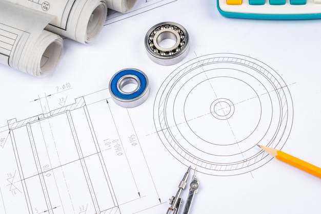 Foto los dibujos de construcción deslizan los cojinetes de rodillos de la pinza en la arquitectura del modelo y el concepto de construcción.