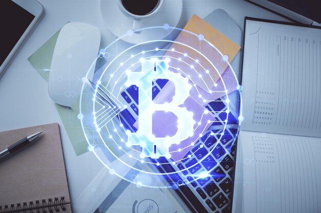 Dibujos de hologramas del tema Blockchain sobre la computadora en el fondo del escritorio Vista superior Concepto de exposición múltiple de criptoeconomía