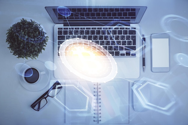 Dibujos de hologramas del tema Blockchain sobre la computadora en el fondo del escritorio Vista superior Concepto de exposición múltiple de criptoeconomía