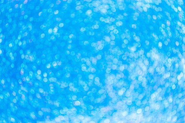Die abstrakte unscharfe blaue Bokeh-Beleuchtung aus glitzernder Textur Defokussierte Lichter Hintergrund blau
