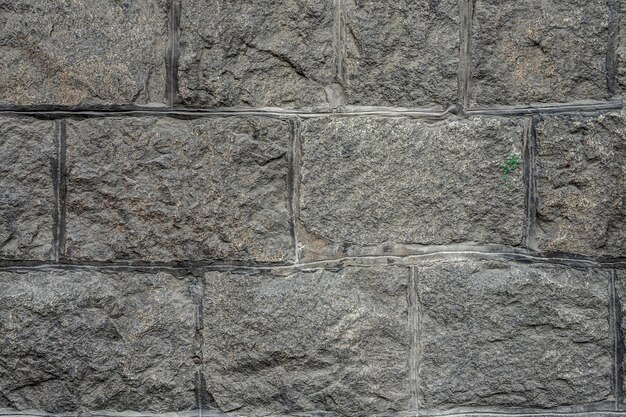 Die antike Wand ist mit grauen Steinen gepflastert Draufsicht Steinstruktur Steinfliesen im Freien