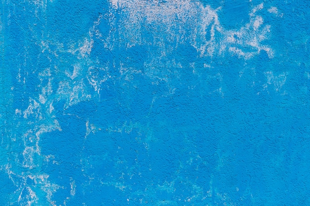 Die Beschaffenheit der Betonzementwand, die in der blauen Farbe mit Weiß gemalt wird, spritzt. Hintergrund für Tapeten