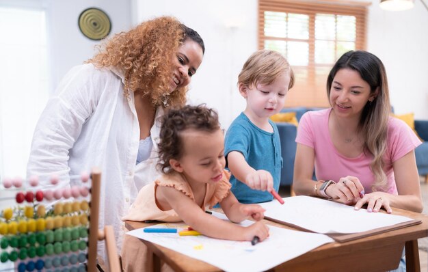 Die Fantasie eines kleinen Kindes wird durch Buntstiftzeichnungen unter aufmerksamer Aufsicht der Mutter im Wohnzimmer des Hauses dargestellt