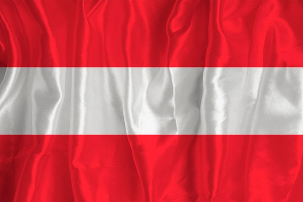 Die Flagge Österreichs auf Seidenhintergrund ist ein großartiges nationales Symbol Stoffstruktur Das offizielle Staatssymbol des Landes Hintergrund der österreichischen Flagge