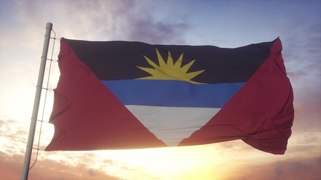 Die Flagge von Antigua und Barbuda weht im Wind-, Himmels- und Sonnenhintergrund. 3D-Rendering.