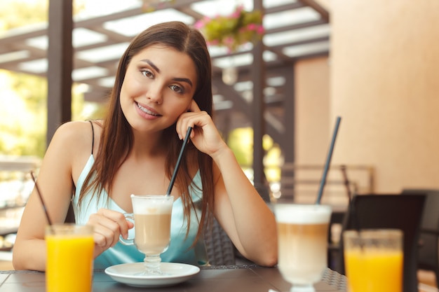 Die frau im café sitzt an einem tisch