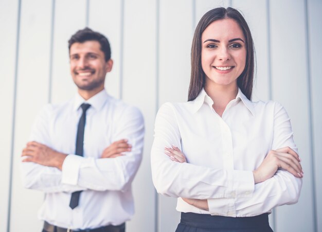 Die glückliche Frau und der Mann stehen im Büro