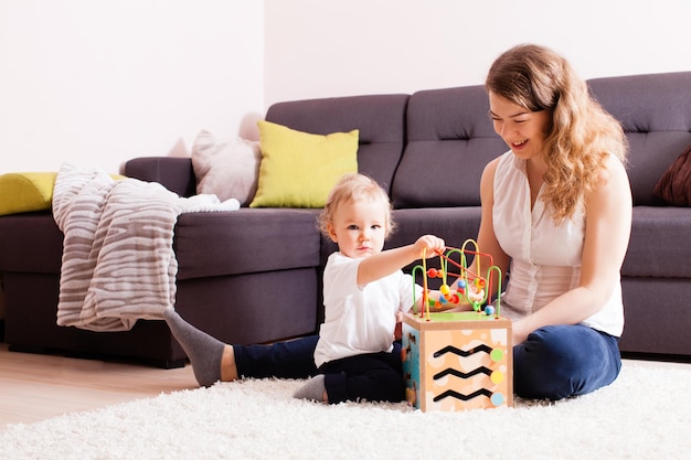 Die Glücksfamilie spielt auf dem Teppich ihres Hauses