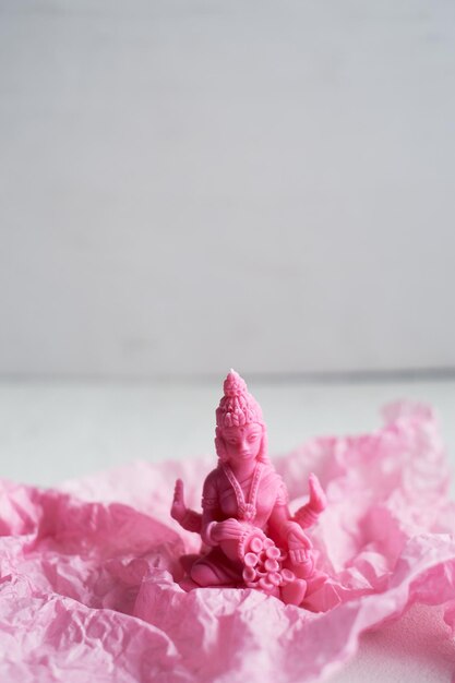 Die Kerze mit der Göttin Lakshmi ist rosa. Weiblichkeit und Fruchtbarkeit, Meditation und Buddhismus