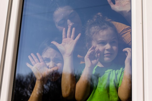 Die Kinder bleiben am Fenster und genießen das Wetter