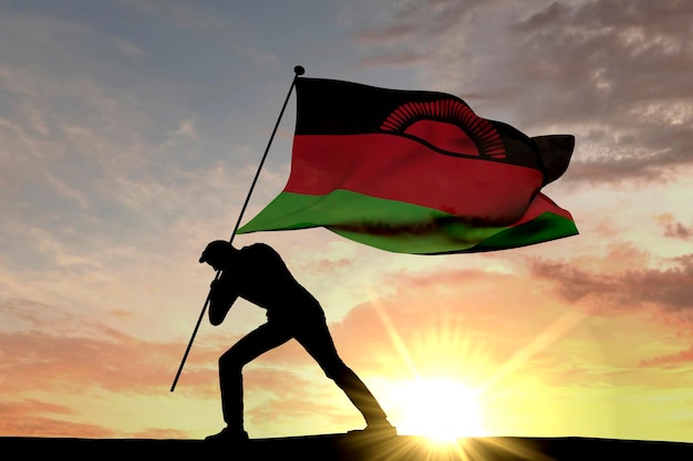 Die Malawi-Flagge wird von einer männlichen Silhouette 3D-Rendering in den Boden gedrückt