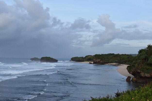 Foto die schönheit des pacitan-strandes mit blauem meer und starken wellen, schöne aussicht, um urlaub und freiheit zu genießen