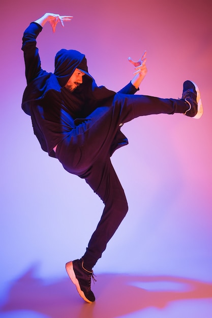 Die Silhouette eines jungen Hip-Hop-Männer Breakdancer tanzt auf buntem Hintergrund