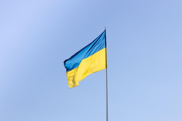 Die Staatsflagge der Ukraine auf einem Hintergrund des blauen Himmels