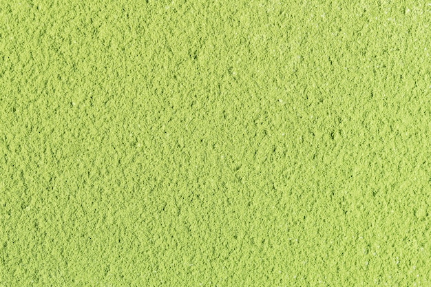 Die textur von grünem matcha-teepulver. draufsicht.