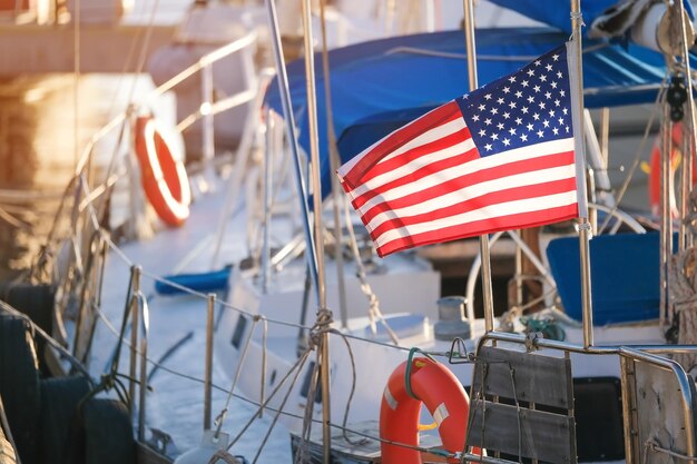 Die usa-amerikanische Flagge flattert im Wind auf einer Segelbootyacht im Hafen