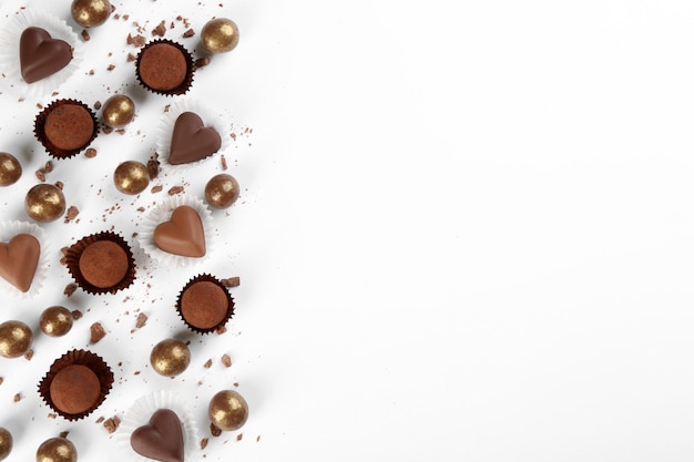 Diferentes deliciosos dulces de chocolate sobre fondo blanco endecha plana Espacio para texto