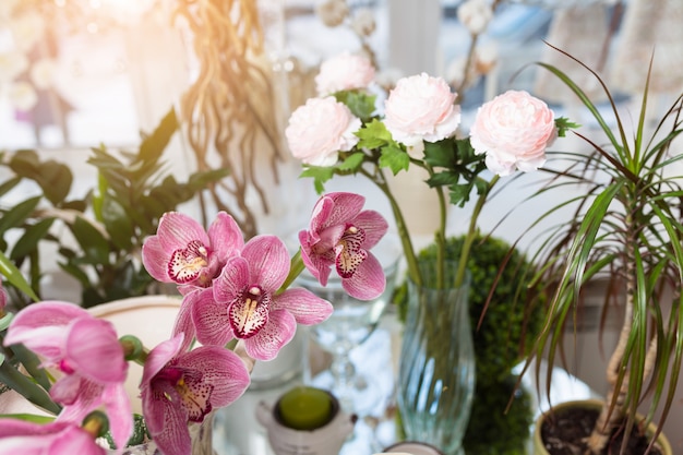 Diferentes flores sobre la mesa blanca en florería