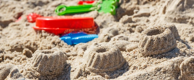 Foto diferentes formas feitas de areia e brinquedos para crianças para relaxar ou brincar na praia de verão tempo de férias de verão e desenvolvimento infantil