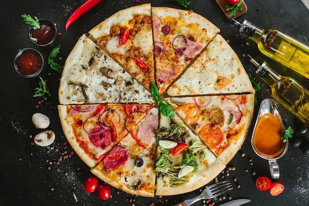 Diferentes pedaços de pizza colocados em uma grande pizza no preto