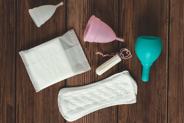 Diferentes tipos de productos de materiales de higiene menstrual femenina, como toallas sanitarias, tampones y copa