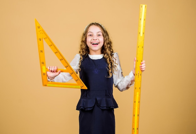 Dimensionamento e medição Estudante de escola estuda geometria Criança uniforme escolar segura régua Aluno linda garota com régua grande Geometria disciplina escolar Educação e conceito escolar Conceito inteligente e inteligente