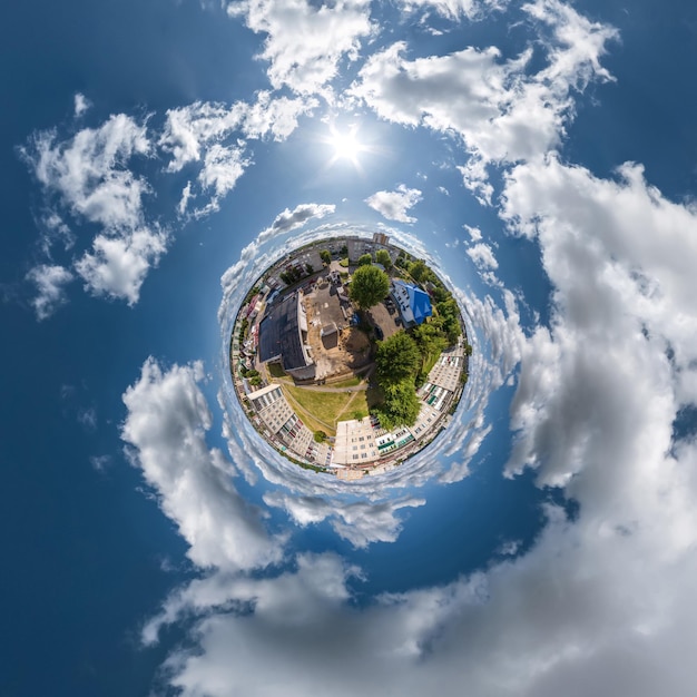 Diminuto planeta en el cielo con nubes con vistas al desarrollo urbano del casco antiguo edificios históricos y cruces Transformación del panorama esférico 360 en vista aérea abstracta