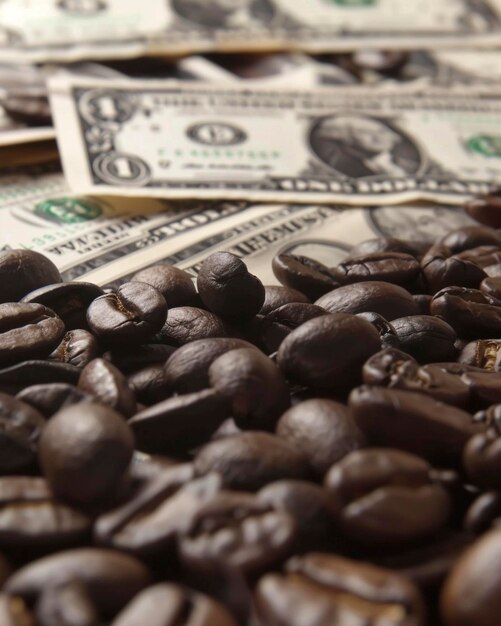 Foto dinero estadounidense cubierto con granos de café de cerca