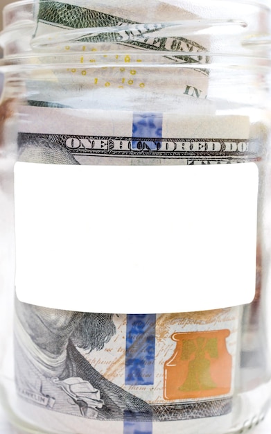 Dinheiro em frasco de vidro com etiqueta em branco Fecha o espaço para o texto