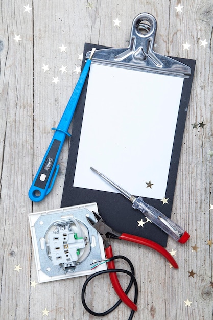 Foto direkt über dem tisch eine ansicht von elektrowerkzeugen mit clipboard