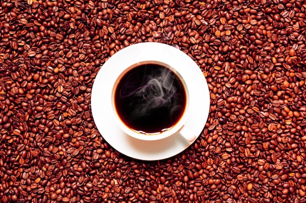 Diretamente acima de um tiro de café preto em meio a grãos torrados