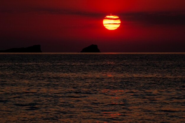 Foto disco solar ao pôr do sol sobre o mar