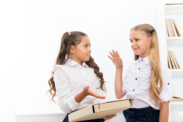 Discutiendo la tarea Ayuda con el proyecto Las colegialas estudian juntas Concepto de educación Actividad grupal Colegialas pequeñas compañeros de clase niños amigables Tarea difícil Colegialas trabajando proyecto escolar