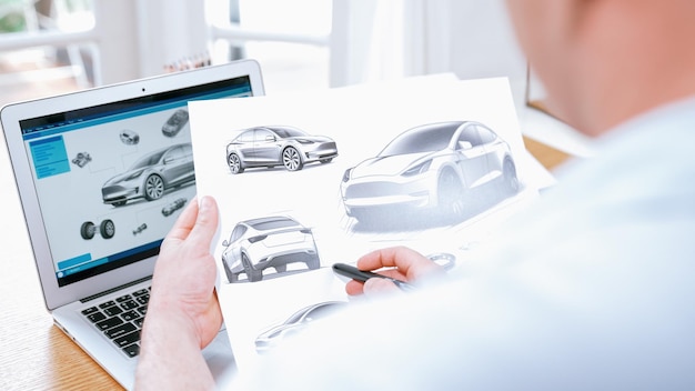 El diseñador de automóviles analizando cuidadosamente los prototipos de automóviles sincrónicos