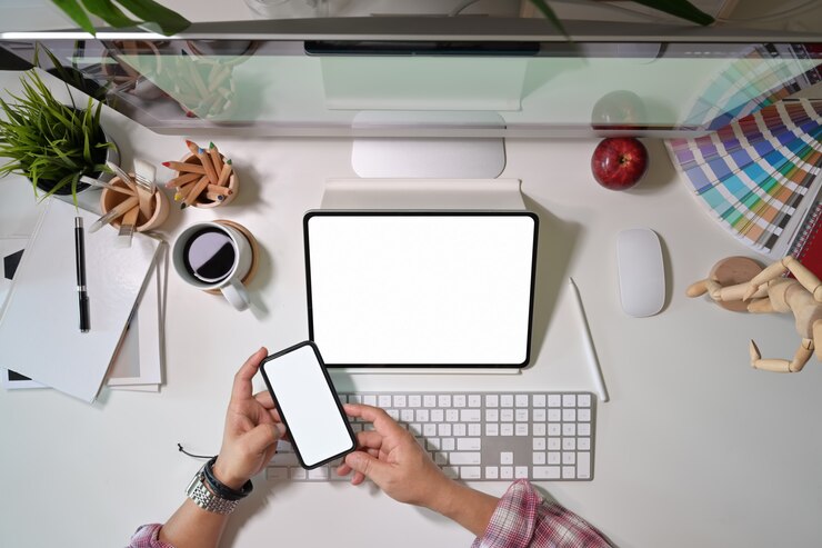 Foto diseñador gráfico creativo usando un teléfono móvil y trabajando con una tableta gráfica digital.