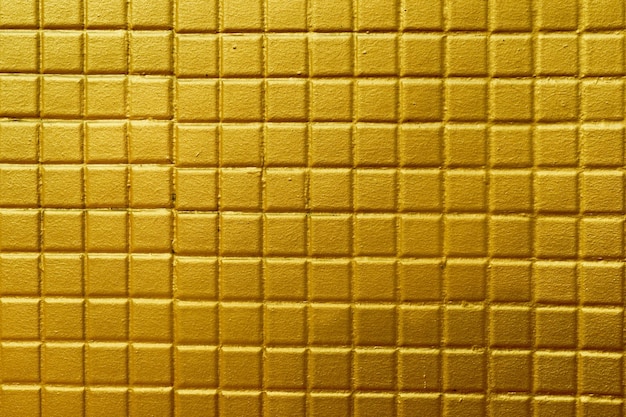 El diseño de estuco de oro de estilo tailandés nativo en la pared