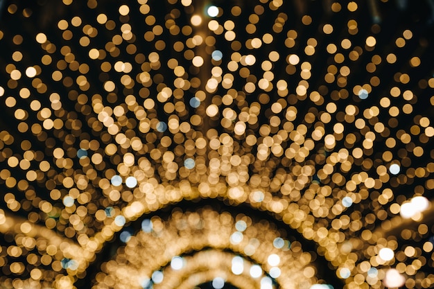 Diseño de fondo de Navidad con luces de bokeh dorado brillante confeti abstracto festivo