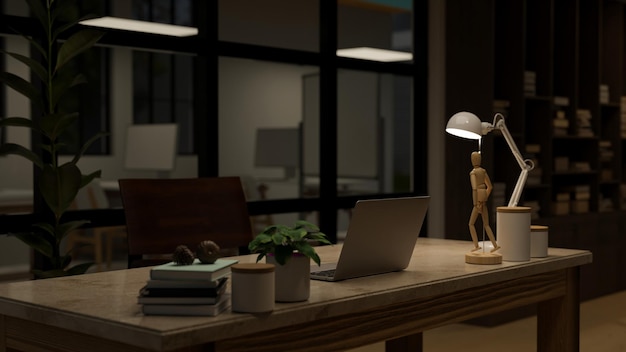 Diseño interior de una oficina moderna por la noche con laptop y decoración en una mesa
