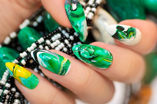 Diseño de moda con un desenfoque en tonos verdes de esmalte de uñas.
