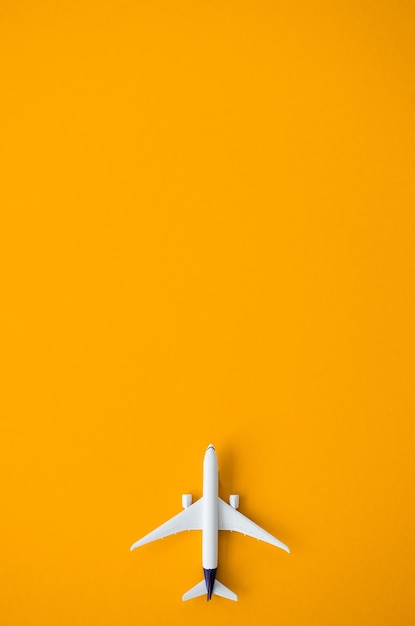 Diseño plano lay de concepto de viaje con avión sobre fondo amarillo