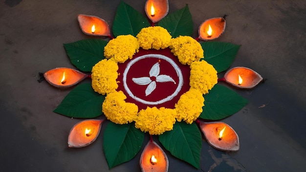 Diseño de rangoli de flor de margarita con lámparas de aceite para el festival de Diwali