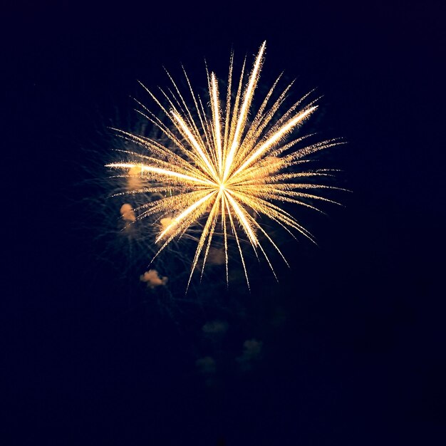 Foto un disparo cuadrado de fuegos artificiales dorados en el cielo oscuro un concierto festivo