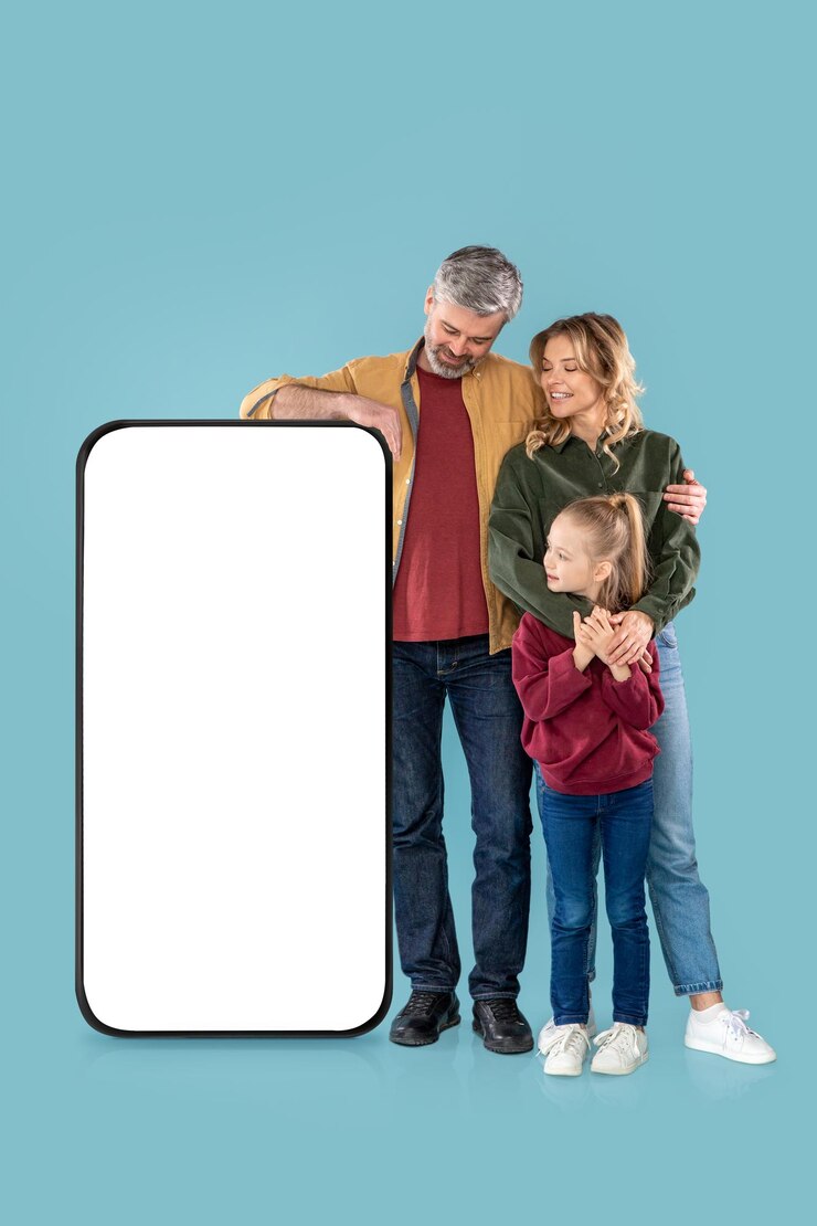 Disparo vertical de la familia de pie cerca de fondo azul enorme teléfono móvil